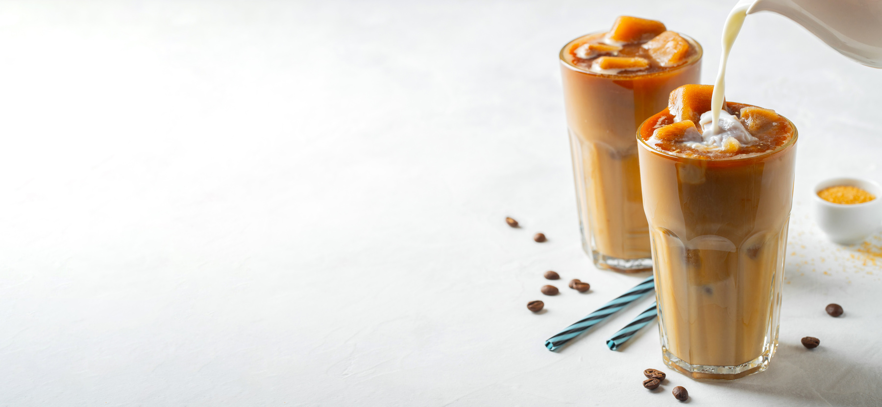Two Glasses of Cold Coffee on White Background.
